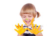 Small girl with yellow paint on her palms