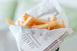 a cone of french fries in fake newspaper