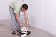 Painter pouring paint can