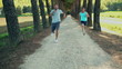 Two young men jogging in summer park, crane shot