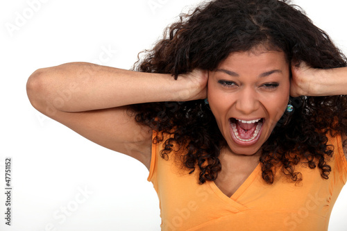 Photo: Woman covering her ears Woman covering her ears