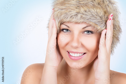 Photo: Beautiful young woman wearing brown fur hat Beautiful young woman wearing brown fur hat