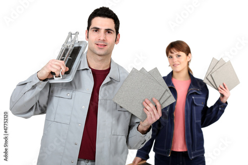 Photo: Couple with a tile cutter Couple with a tile cutter