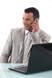 Worker on the phone in front of computer