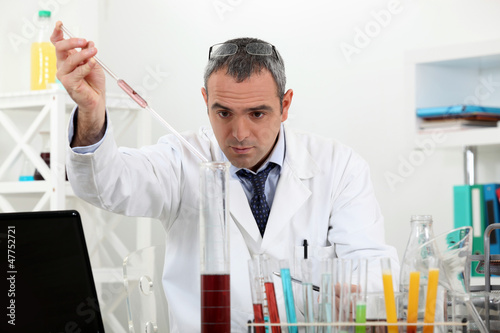 Photo: Scientist in a lab experiment Scientist in a lab experiment
