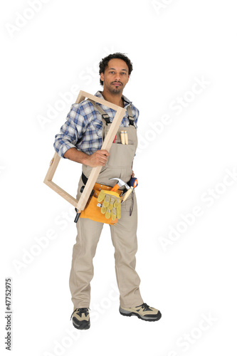 Photo: carpenter holding a window frame carpenter holding a window frame