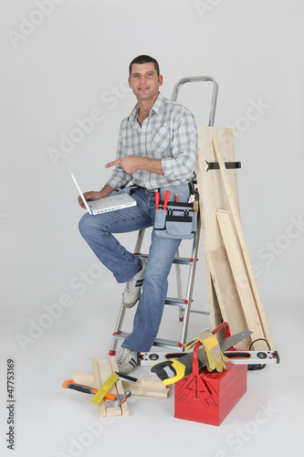 Photo: Carpenter with a laptop Carpenter with a laptop