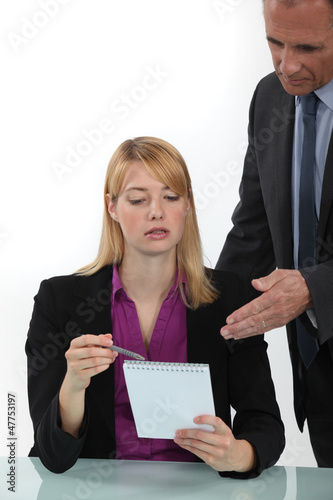 Photo: Woman explaining point to boss Woman explaining point to boss