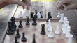 Active retired people, two senior men playing chess at park