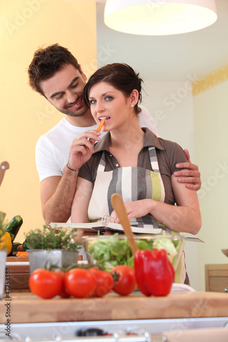 Photo: Young couple in their kitchen Young couple in their kitchen