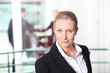 Blonde woman in front of rail
