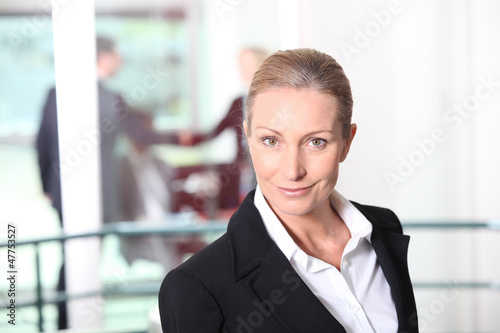 Photo: Blonde woman in front of rail Blonde woman in front of rail