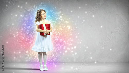 Photo: Happy girl opening gift box Happy girl opening gift box