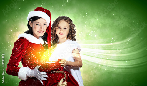 Photo: Little girl with christmas gifts and santa Little girl with christmas gifts and santa
