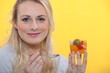 Blond woman holding fruit salad