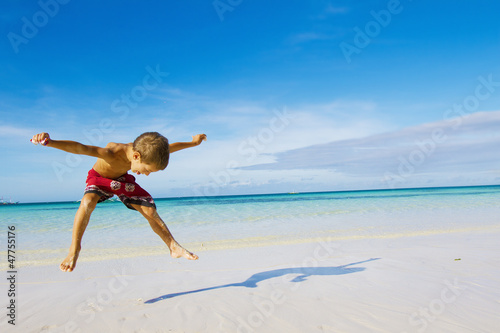 Photo: young happy child boy on tropical beach young happy child boy on tropical beach