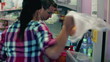 Young couple paying for shopping in supermarket, steadicam shot 
