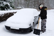 Photo: Man need again remove snow from the car Man need again remove snow from the car