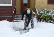 Photo: Man removing snow in front of his house Man removing snow in front of his house