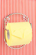Roll of toilet paper on  holder fixed to pinstriped wall