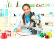 Young scientist looking into  microscope in  laboratory.