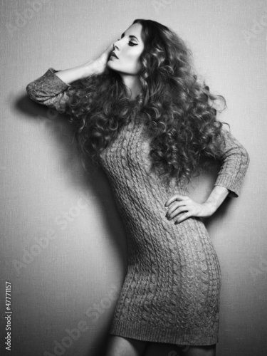 Photo: Portrait of beautiful woman in knitted dress Portrait of beautiful woman in knitted dress