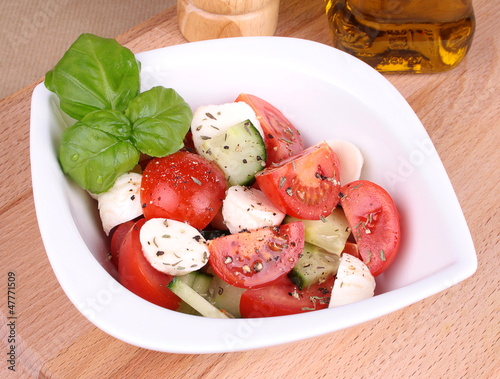 Photo: Fresh tomato and mozzarella salad with cucumber and basil Fresh tomato and mozzarella salad with cucumber and basil