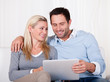 Couple looking at a tablet together
