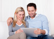 Couple looking at a tablet together