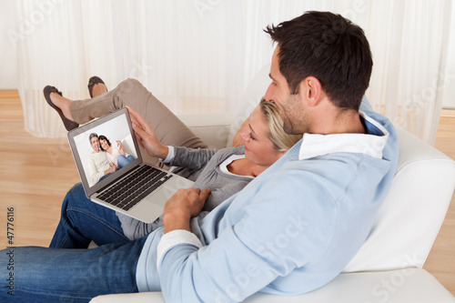 Photo: Loving couple having video conference Loving couple having video conference