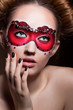 Painted Face. Beautiful Girl in Red Carnival Mask. Masquerade