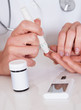 Photo: Doctor testing a patients glucose level Doctor testing a patients glucose level