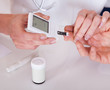Doctor testing a patients glucose level
