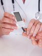 Doctor testing a patients glucose level
