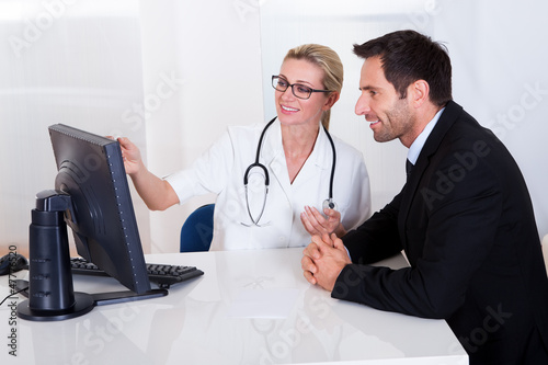 Photo: Doctor explaining something to a male patient Doctor explaining something to a male patient