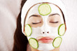 Woman with cucumber slices on the face