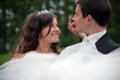 Newly married couple dancing in field