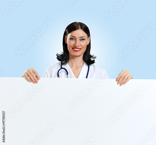 Photo: Young female doctor with a banner Young female doctor with a banner
