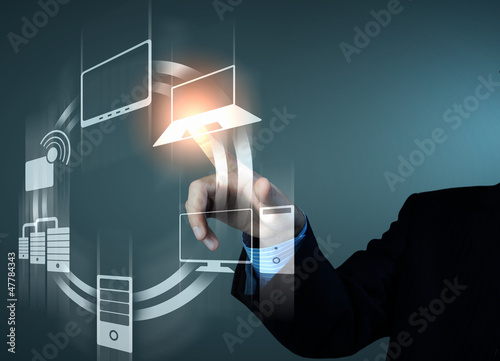 Photo: hand pushing on a touch screen hand pushing on a touch screen