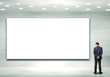 Business person standing near a blank billboard