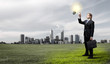 Photo: Businessman holding light bulb Businessman holding light bulb