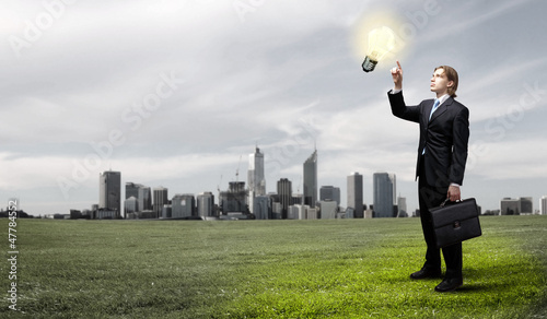Photo: Businessman holding light bulb Businessman holding light bulb