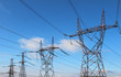Photo: four power high voltage tower over blue sky four power high voltage tower over blue sky