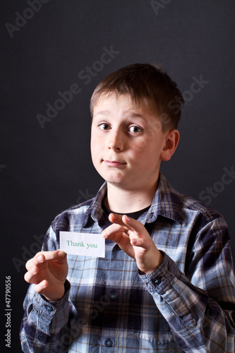 Photo: boy shows a card with gratitude boy shows a card with gratitude