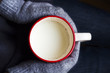Cup of milk in hand with gloves