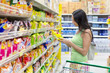 Woman buys potato chips in the store