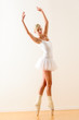 Beautiful ballet dancer practicing dance posture