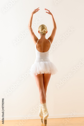 Photo: Ballerina pose from behind dancing in studio Ballerina pose from behind dancing in studio