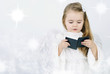 A beautiful little girl angel with a book