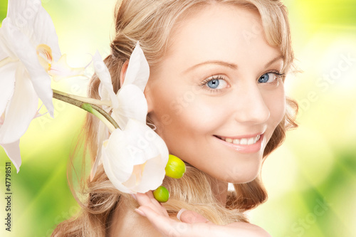 Photo: beautiful woman with orchid flower beautiful woman with orchid flower